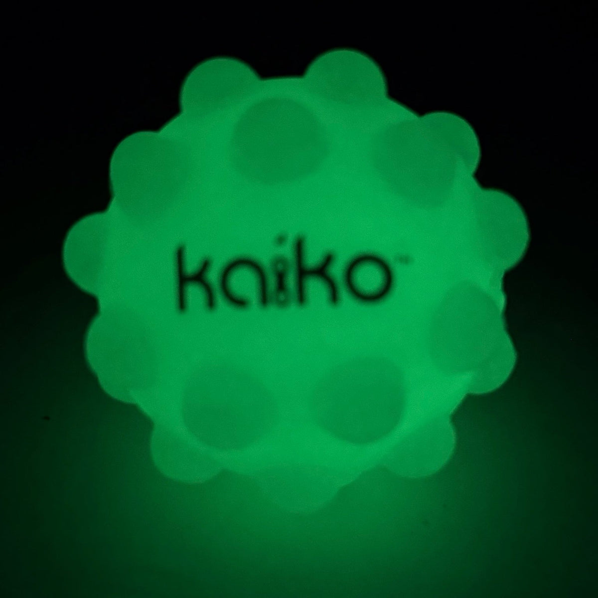 Kaiko Pop It Squishy Ball glowing green in the dark