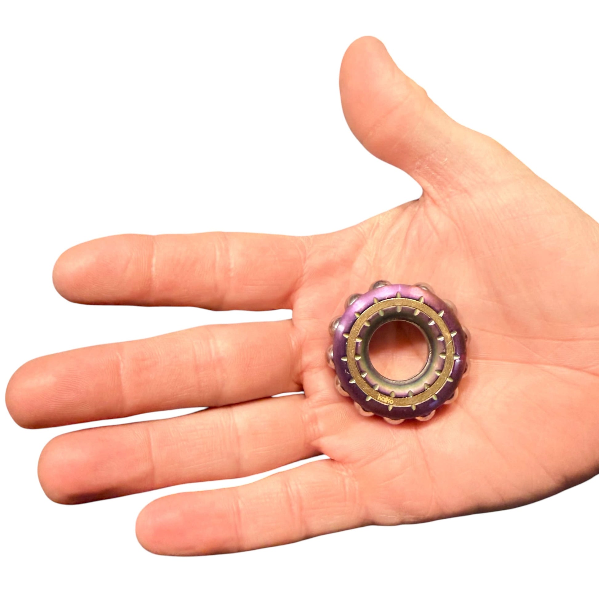 Freewheel Spinner resting in an adult hand for scale