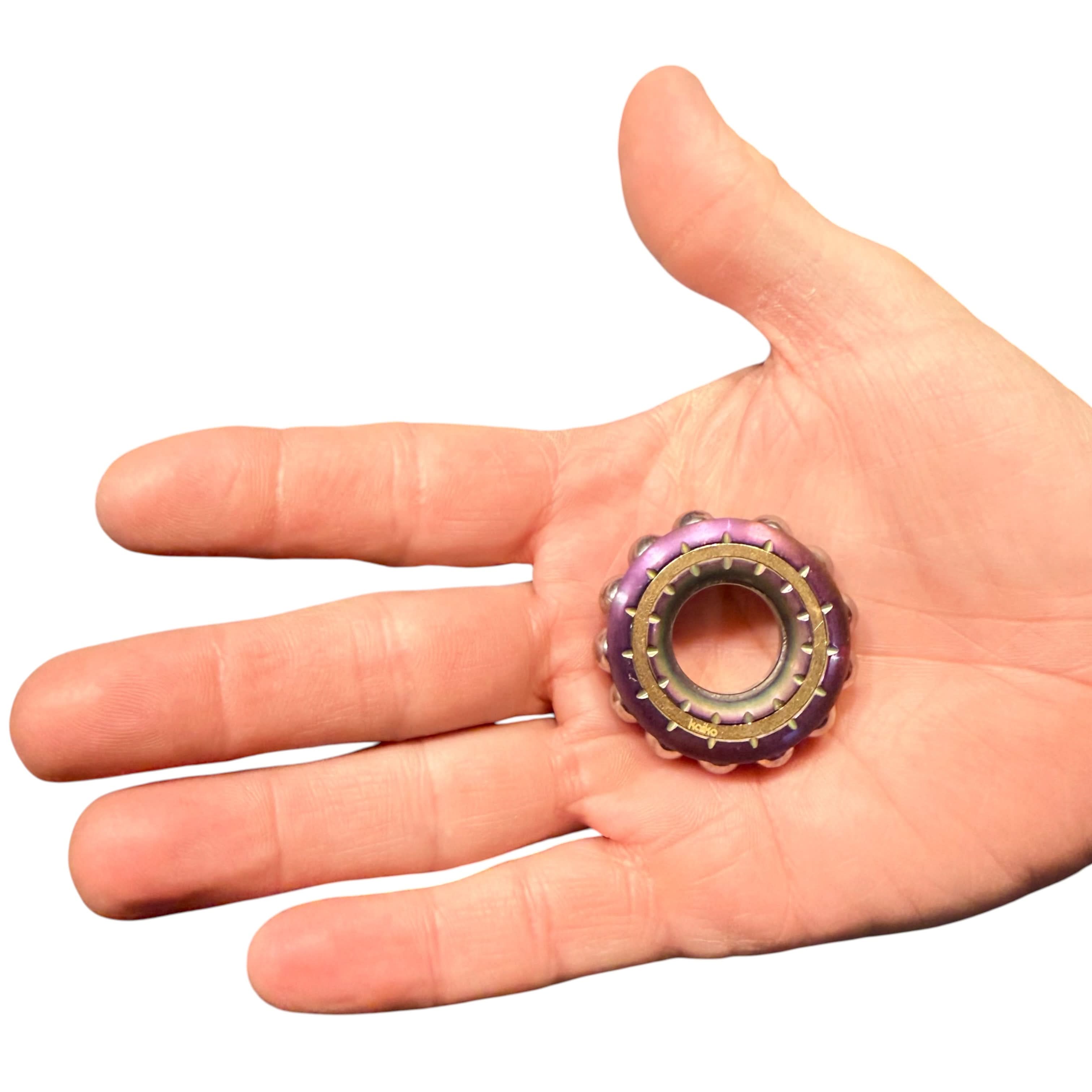 Freewheel Spinner resting in an adult hand for scale