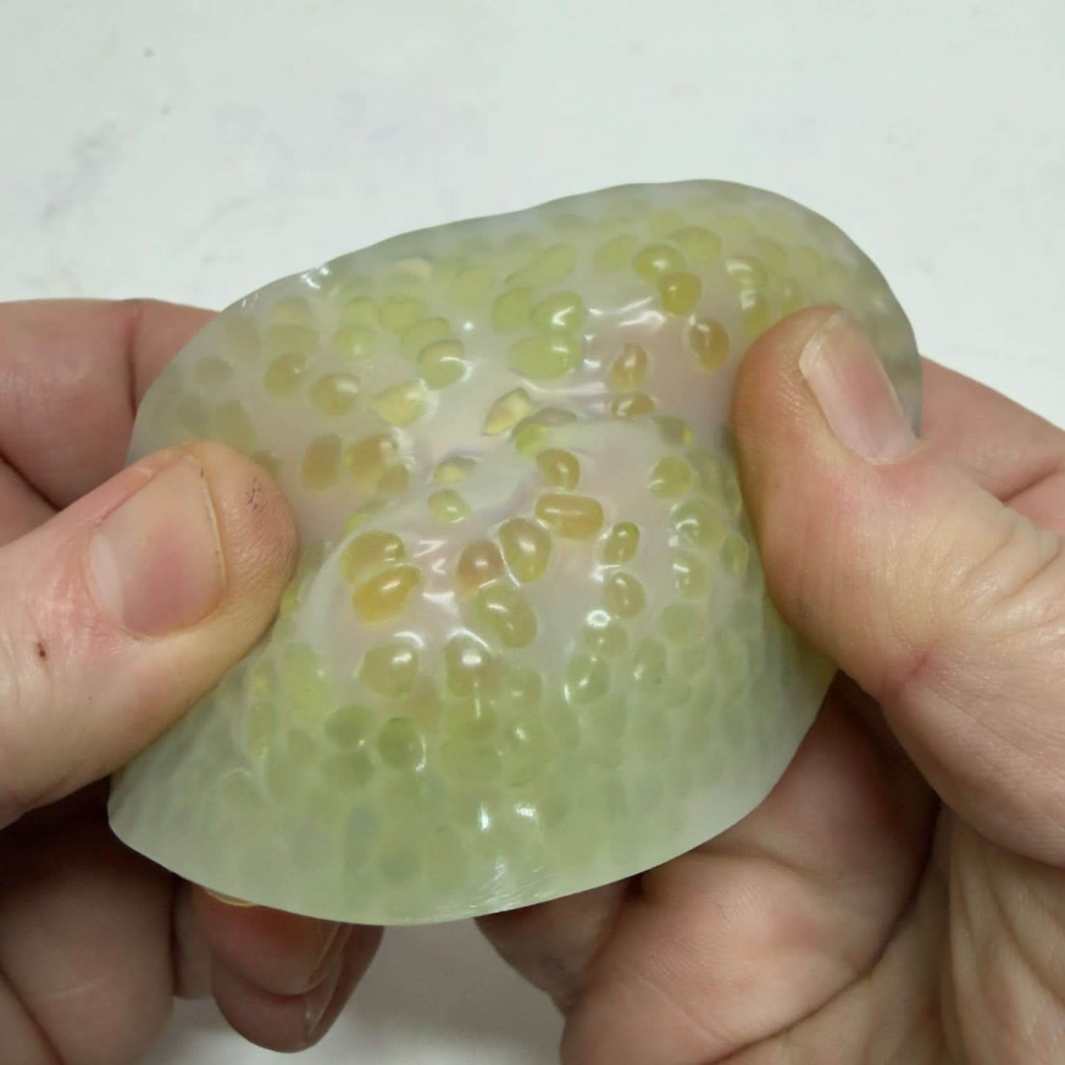 Green Vivid Stretchy Pick 'Em close-up in hand