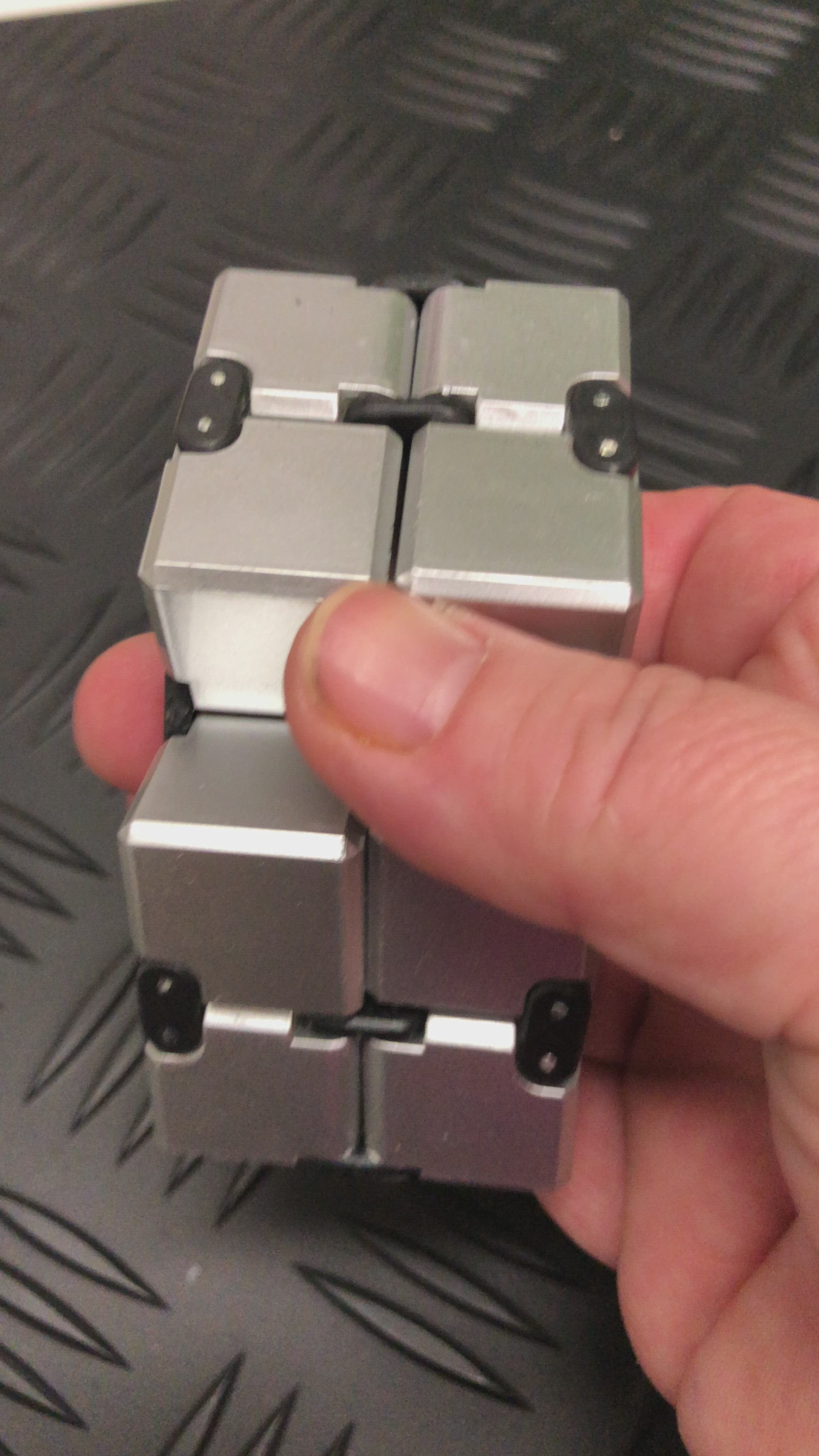Load video: Silver Infinity Cube Fidget - 108 grams